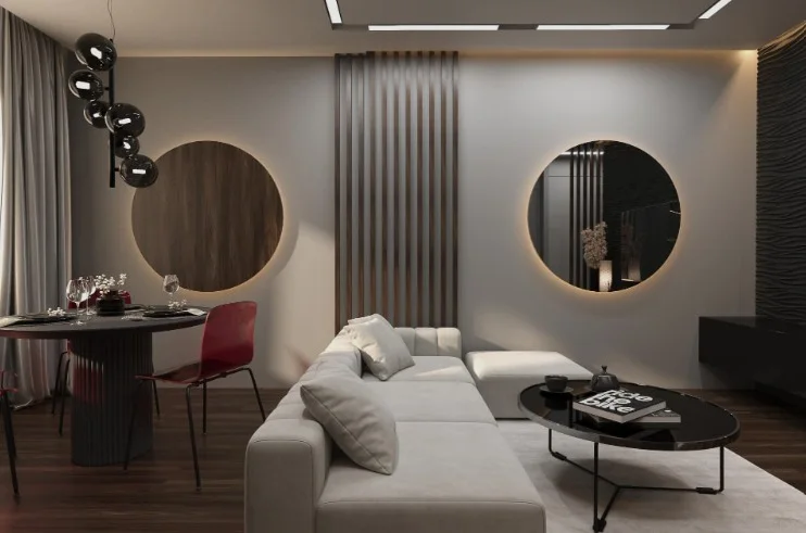 Open-plan living and dining room with a grey sectional sofa, backlit round panels on the feature wall, a wood-slat partition and a bubble pendant chandelier